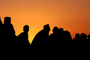 Silhouette of group of men at dusk